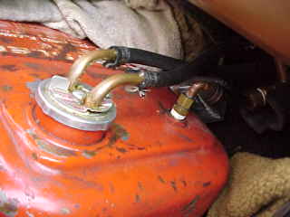 The copper coil carries hot engine coolant into and out of the tank.